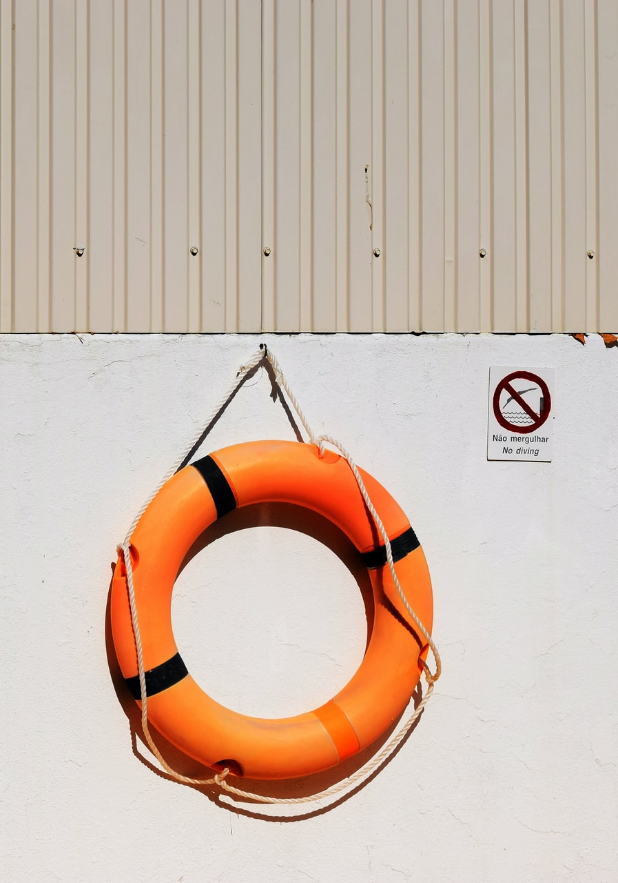 An image of a life ring hanging on a boat wall